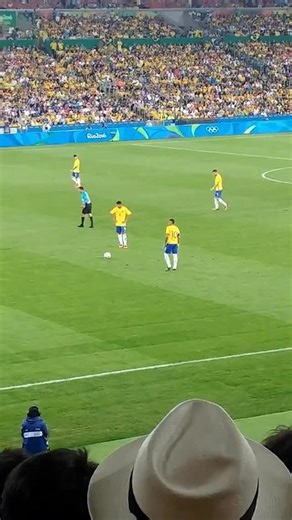 NJ 10 | Fanpage on Instagram: "😳 The scoreboard read 0–0 when Brazil earned a free kick just outside the German box in the 27th minute. Neymar, wearing the captain’s armband, stood over the ball, eyes locked on the goal. The crowd held its breath. He took a few short steps, curved his right foot around the ball, and watched as it sailed over the wall. It hit the crossbar and dropped into the net. For a split second, silence and then an explosion of sound. Brazil was ahead 1–0, and their dream o