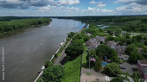 view of river and public park in hudson new york with distant mountains and marsh (small town downtown train tracks station) promenade hill scenic drone view footage