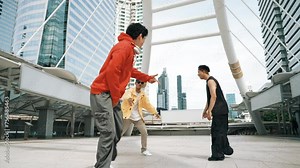 Skilled hipster dancing together while perform footstep at city. Professional break dancer moving to music while looking at camera. Low angle camera. Modern lifestyle. Outdoor sport 2024. Sprightly.