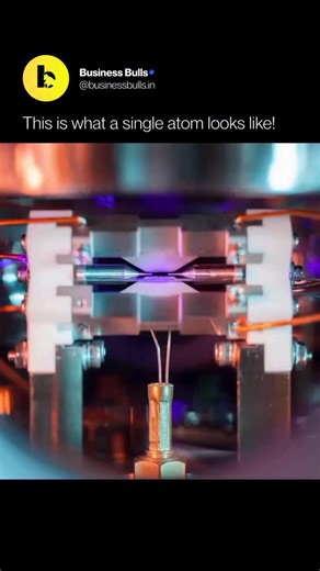 Business Bulls | AI on Instagram: "Captured by physicist David Nadlinger, this striking image shows a single strontium atom suspended between two electrodes. Lasers excite the atom until it absorbs and re-emits light, making it visible without a microscope. The photo brings quantum physics into human view, revealing a basic building block of reality floating in a vacuum. Credit: David Nadlinger/University of Oxford Liked this content? Follow @Businessbulls.in for more! #Businessbulls #Science"