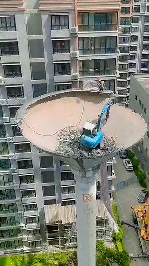 Excavator Defies Heights to Demolish a Water Tower #excavator #construction #trending | Construction Machines