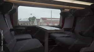 Comfortable seat in first class on TGV train first class. French train interior without people. Seats 1 class with table by window. Railway in France. Empty seats in a 1st class TGV wagon in France.