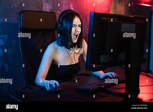 Technology, Gaming, Entertainment, Let's play and people concept - Angry screaming young girl in headset with PC computer playing game at home and streaming playthrough or walkthrough video Stock Photo - Alamy