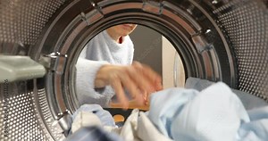 A broken washing machine. Women Housewife takes out laundry and a broken element the washing machine. Woman has problem with washing machine. View Looking Out From Inside Washing Machin Stock Video