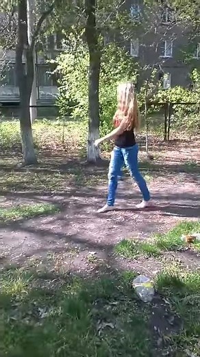 Girl Walks Barefoot along Grass Path