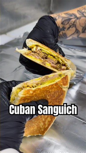 Tremendo Sanguich Cubano! Mustard, pickles, roasted pork, Swiss cheese & sweet ham from end to end.