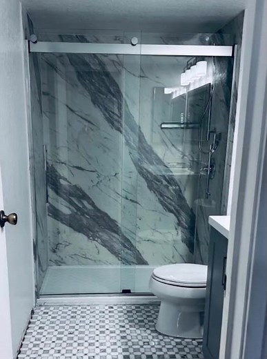 Check out this stunning Kohler walk-in shower with Luxstone panels! ✨ #ShowerRemodel #KohlerShower