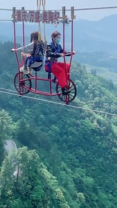 104K views · 1.4K reactions | A pair of brave girls were spotted cycling mid-air in a display of bravery at a popular tourist spot in southwest China's Chongqing. The daredevils had the adventure with safety measures in place. #FunChina | China Plus Culture | Facebook