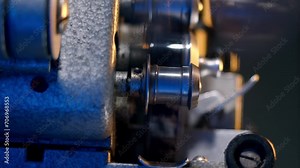 Close up view of metal shiny 16mm reels of vintage film projector in movie theater. Screensaver for documentary about history. Retro equipment works without failures and film is played.
