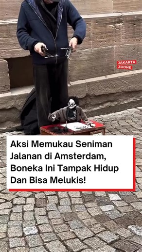 Jakarta Zoone on Instagram: "Sebuah penampilan seni jalanan yang unik di Amsterdam berhasil menarik perhatian publik. Sang dalang, Raphael Gromy, memperlihatkan keahlian luar biasa dalam menggerakkan sebuah boneka berkarakter pelukis dengan sangat realistis. Dalam momen yang diabadikan, terlihat interaksi menyentuh antara boneka tersebut dengan seorang wanita yang sedang memberikan apresiasi. Hanya dengan beberapa gerakan tangan yang halus dari sang dalang, boneka itu tampak menatap dan menunjuk