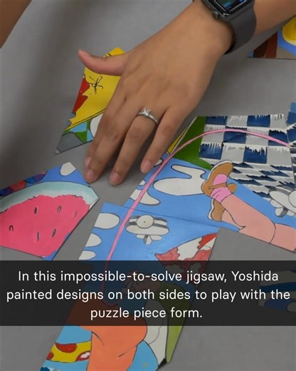 Video Description: Different multi-colored puzzle pieces are laid out as a person attempts to complete the jigsaw. Text on Screen: In this impossible to solve jigsaw, Yoshida painted designs on both sides to play with the puzzle piece form. | Smithsonian