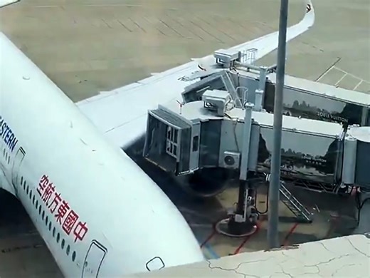 Airplane crashes into jet bridge