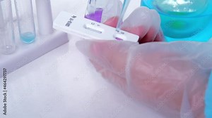 laboratory assistant doing a test for covid-19, test tubes, glass vials with colored solutions, liquids for scientific research, medical laboratory scientific research