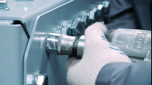 Master working with screwdriver during assemble at factory. Industrial tool