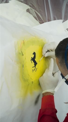 StreetArtGlobe ™ 😱 on Instagram: "Did you know that Ferrari’s famous logo is hand painted? 🤯🤷🏽‍♂️ Ferrari’s hand-painted fender shield, known as the Scudetto Aerografato, is one of the most exclusive and artisanal options offered through the brand’s personalization program. Unlike the standard raised plastic badge, this version is meticulously airbrushed directly onto the fender by Ferrari’s master craftsmen in Maranello. Each shield is painted by hand using layers of vibrant color and clear