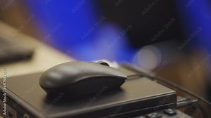 black computer mouse close-up. Click black computer mouse on a work desk. Working with a PC or laptop at workplace, close-up