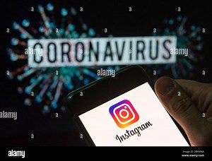 In this photo illustration the American photo and video-sharing social networking service owned by Facebook, Instagram, logo seen displayed on a smartphone with a computer model of the COVID-19 coronavirus on the background Stock Photo - Alamy