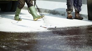 Process of asphalting road construction infrastructure by spraying or casting prime coat, tack coat or gluing the ATB layer with hot mix asphalt | Premium Stock Video Footage