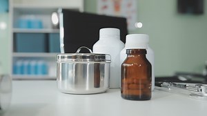 Download Doctor and nurse examining patient's medical records and medical team working on the background for free