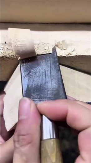 carving and shaping curved patterns on pieces of wood using sharp steel wood chisels