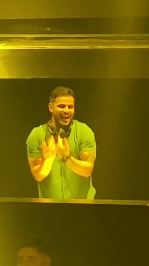 Dynamic DJ Performance in a Lively Nightclub Atmosphere