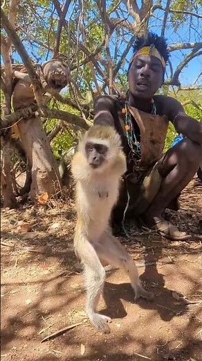 The African Hunters caught a monkey and were having fun with it