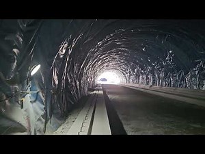 Setting the first foundation of a concrete machine-cast tunnel joint and attaching a vibrator (lo...