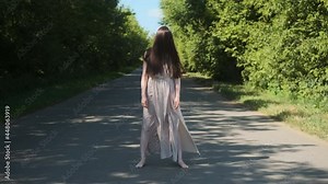 scary ghost woman in an old dress with hair covering her face, shows her finger at the camera. Horror on the road creepy day for travelers.