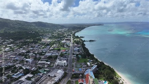 Trace the path of endurance in paradise. This sweeping aerial footage captures the renowned coastal running course along Saipan's west coast, famous for hosting international marathons. Stretching fro