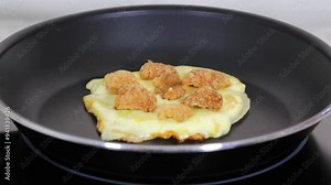 Delicious arepa with melted mozzarella cheese and pan fried chicharron carnudo or pork rinds.