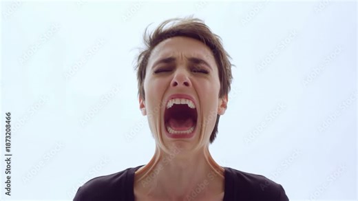 Woman expresses intense emotion progressing from calm to scream against white background