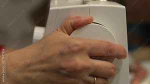 Setting up a sewing machine. Embroidery. Threads. Ball of yarn. Needles. Sewing machine. Close-up