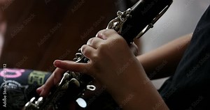 Child Learning How to Play the Clarinet Instrument 10bit, 4K