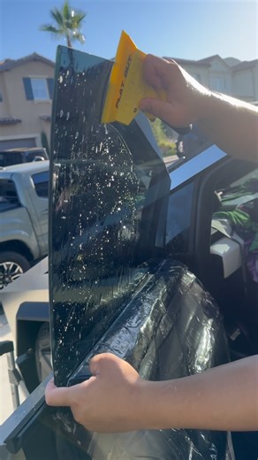 Tint God™️ on Instagram: "Early bird 礪. Exceptional outside installation service for this Cybertruck getting that i3 ceramic film installed on all windows plus windshield. Watch the outdoor tinting process on this Cybertruck side window"
