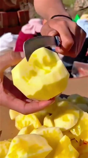 The process of cutting an apple manually using a sharp knife is very easy for anyone to do