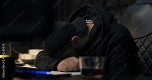 Young programmer sleeps on desk in front of computer at night, man fell asleep during night shift, hacking internet, programming website, tired work guy.
