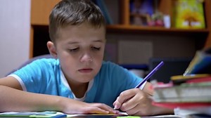 clip-1060912570-talented-boy-draws-colored-pencils-home-schooling