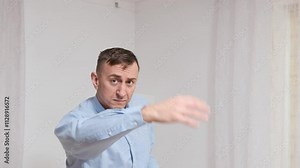Actor in a blue shirt makes various hand gestures in slow motion, showcasing body language skills