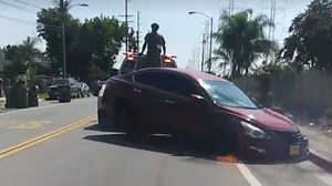 Wild Video Shows Tow Truck Dragging Repo'd Nissan Altima While Owner Tries to Free It