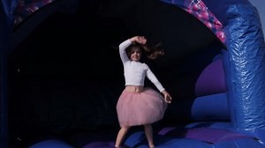 clip-3654501879-4k-young-girl-bouncing-on-bouncy-castle