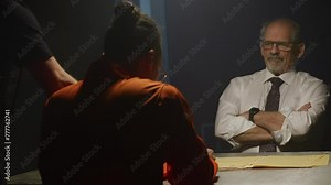 Cop detective questioning inmate on cold case file Stock Video