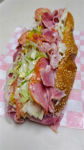 This is how we make hoagies Philly-style! 🥖🔥💯 This is our Italian hoagie. If this looks like your kind of sandwich, swing by our Schererville or Hammond spot and grab one! 😎🥪 Genoa salami, smoked ham, capicola, provolone, lettuce, tomato, onion, red wine vinegar, olive oil, salt, pepper, and oregano… all stacked up fresh and crazy good! 🤤🥬🧀🍅...(Seeded Semolina roll is optional.) Like/Follow/Share | Jodi's Italian Ice Factory