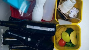 Different bins full of garbage, sorting of glass, plastic and paper, recycling