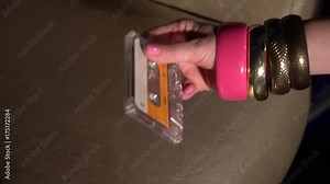 girl inserts a tape in the recorder