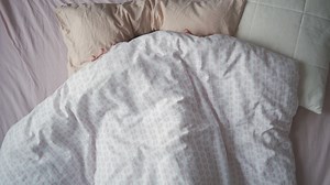 Portrait of a woman waking up in her bed - Free Stock Video