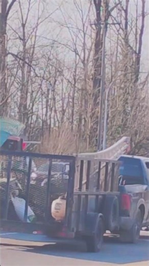 pick up truck with very wide trailer on the street