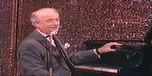 Danish comedian Victor Borge plays "piano jokes" that have the crowd roaring