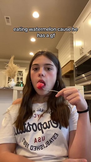 Eating Watermelon in a Modern Kitchen Setting