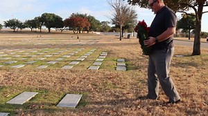 In this video it is demonstrated how to place a wreath on a grave marker. | Wreaths for Vets