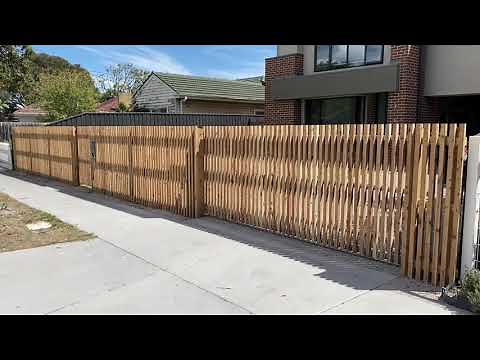 Batten style front fence with automatic sliding gate